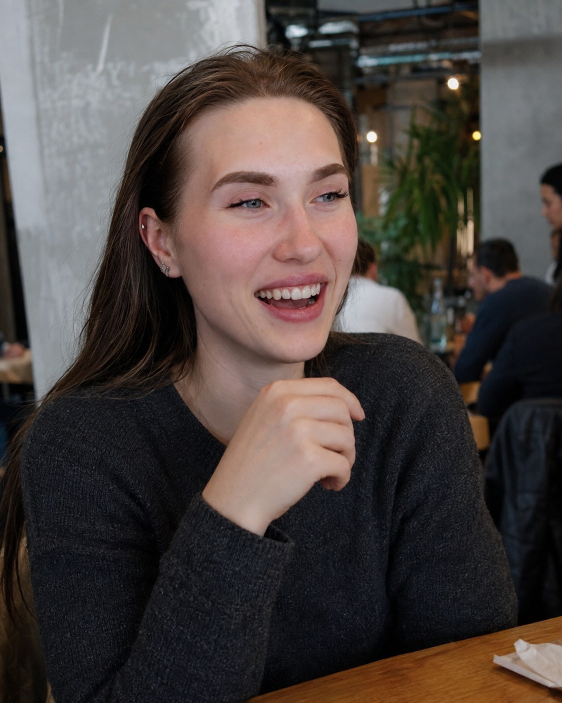 Generated portrait of the reference character laughing in a café